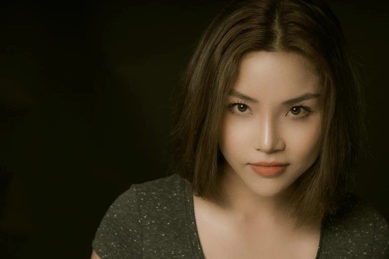 a woman posing for a picture in a dark room, a character portrait, inspired by Ina Wong, unsplash, photorealism, actress, on a gray background, young cute wan asian face, pokimane