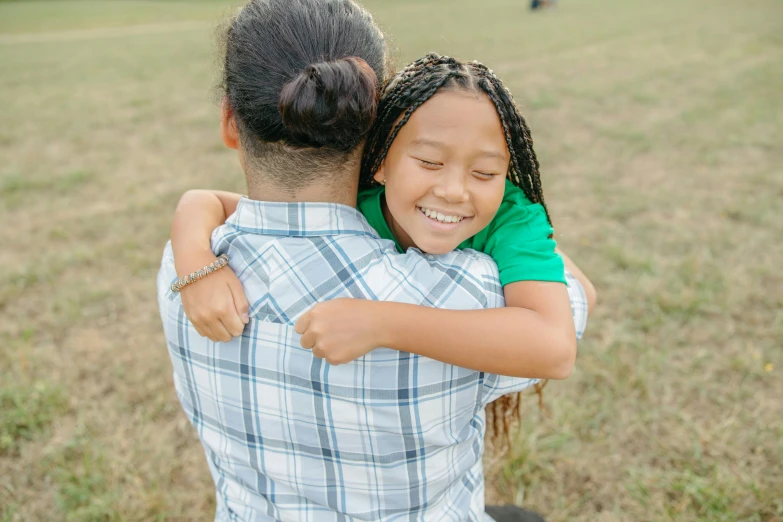 a little girl hugging a man in a field, pexels contest winner, happening, varying ethnicities, woman with braided brown hair, 15081959 21121991 01012000 4k, a green