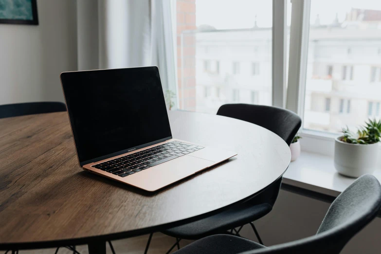 a laptop computer sitting on top of a wooden table, unsplash, office furniture, background image, round format, sydney hanson