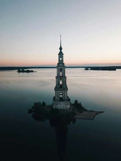 a tower in the middle of a body of water, inspired by Konstantin Vasilyev, pexels contest winner, russian neoclassicism, lit from above, profile picture 1024px, archipelago