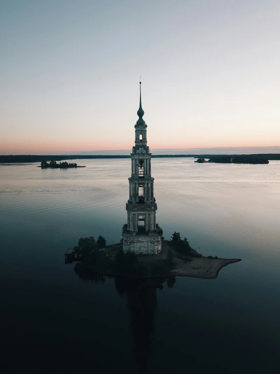 a tower in the middle of a body of water, inspired by Konstantin Vasilyev, pexels contest winner, russian neoclassicism, lit from above, profile picture 1024px, archipelago