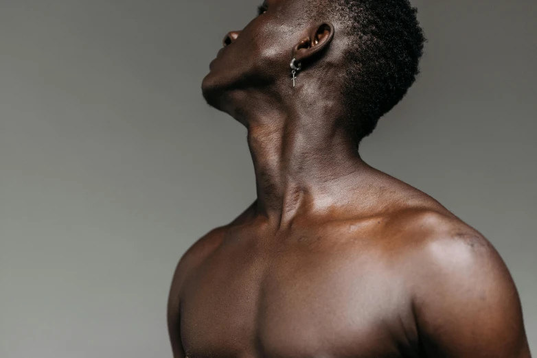 a close up of a man with no shirt on, trending on pexels, bust with a long beautiful neck, dark grey skin, full body profile, waxy skin