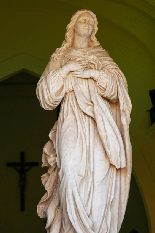 a statue of a woman holding a cross, inspired by Giovanni Battista Innocenzo Colombo, renaissance, modest flowing gown, standing inside of a church, magnificent oval face, up-close