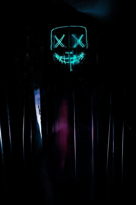 a person in a dark room with a neon mask, an album cover, reddit, conceptual art, vivid), cross-eyed, dark. no text, scary smile