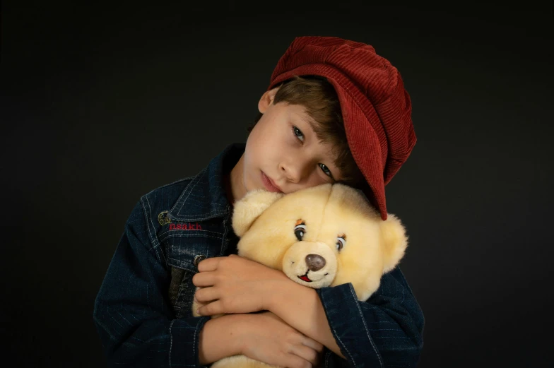 a young boy holding a teddy bear in his arms, an album cover, inspired by George Barker, pexels, realism, berets, frown fashion model, soft lighting, toys