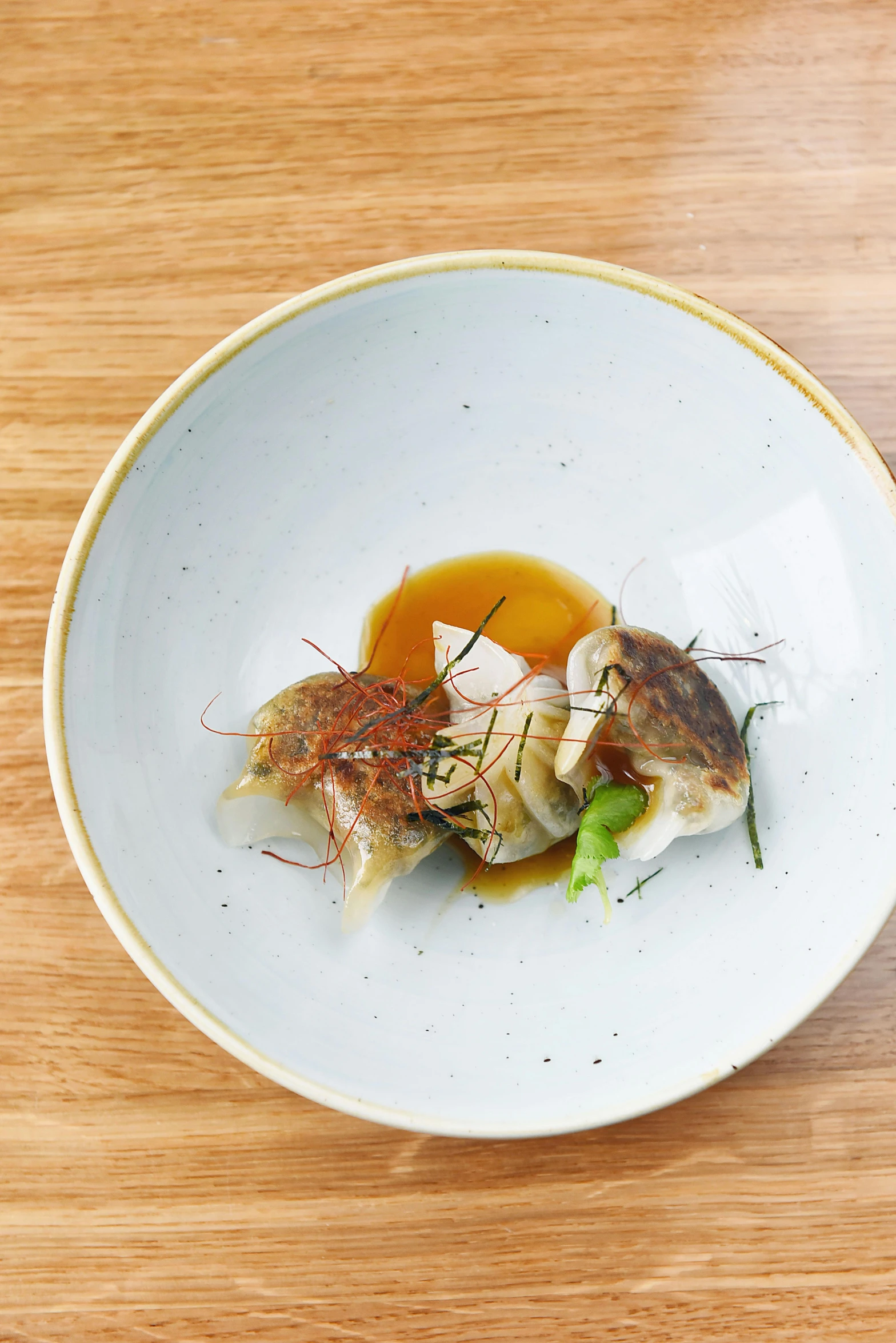 a close up of a plate of food on a table, inspired by Barthélemy Menn, dumplings on a plate, cuttlefish, けもの, honey