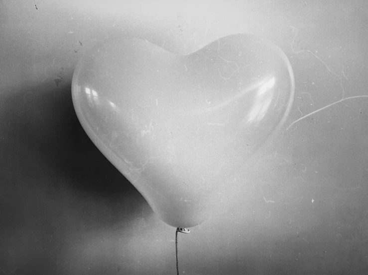 a black and white photo of a heart shaped balloon, glass negative, 1/320, unknown location, blank