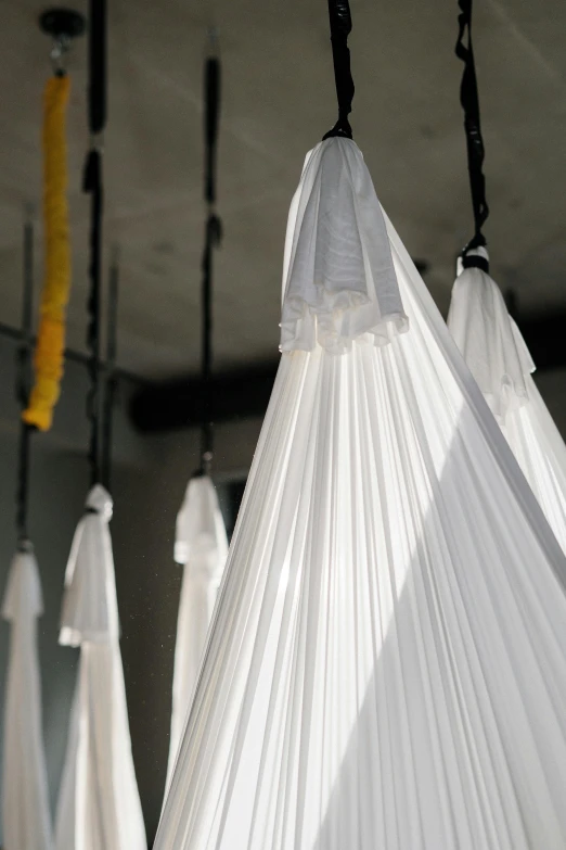 a group of umbrellas hanging from the ceiling, by Nina Hamnett, gutai group, white robes, incubator medpods, close-up photo, lamp ( ( ( gym ) ) ) )