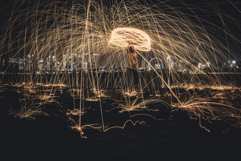 steel wool spinning in the air over a city at night, by Daniel Lieske, pexels contest winner, flaming torches and pitchforks, by greg rutkowski, album art, alessio albi