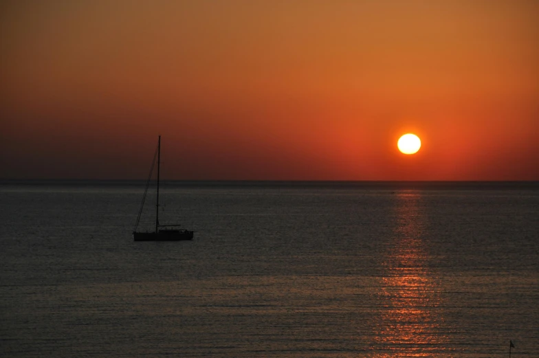 a sailboat in the middle of the ocean at sunset, by Jan Tengnagel, pexels contest winner, romanticism, agrigento, grey, orange sun set, minimalissimo