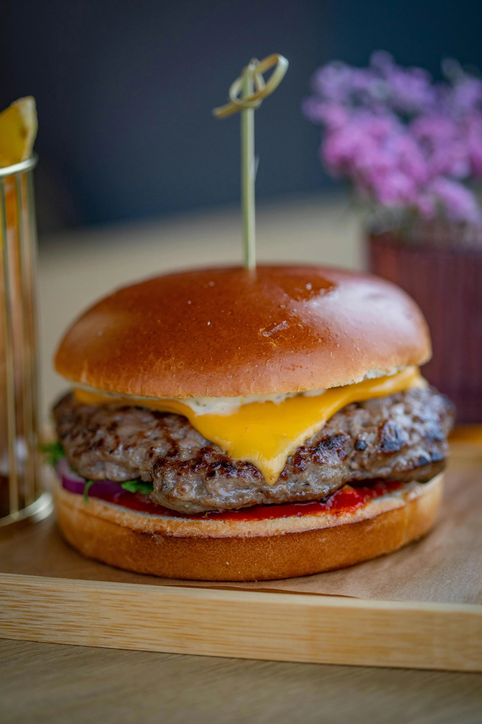 a hamburger sitting on top of a wooden cutting board, a picture, by Adriaen Hanneman, unsplash, melted cheddar, pbr, large portrait, 15081959 21121991 01012000 4k