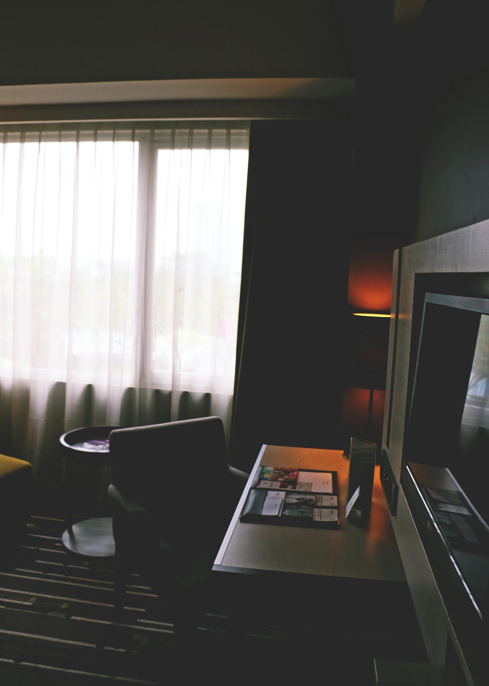 a living room filled with furniture and a flat screen tv, unsplash, happening, hotel room, gloomy skies, low quality photo, utrecht