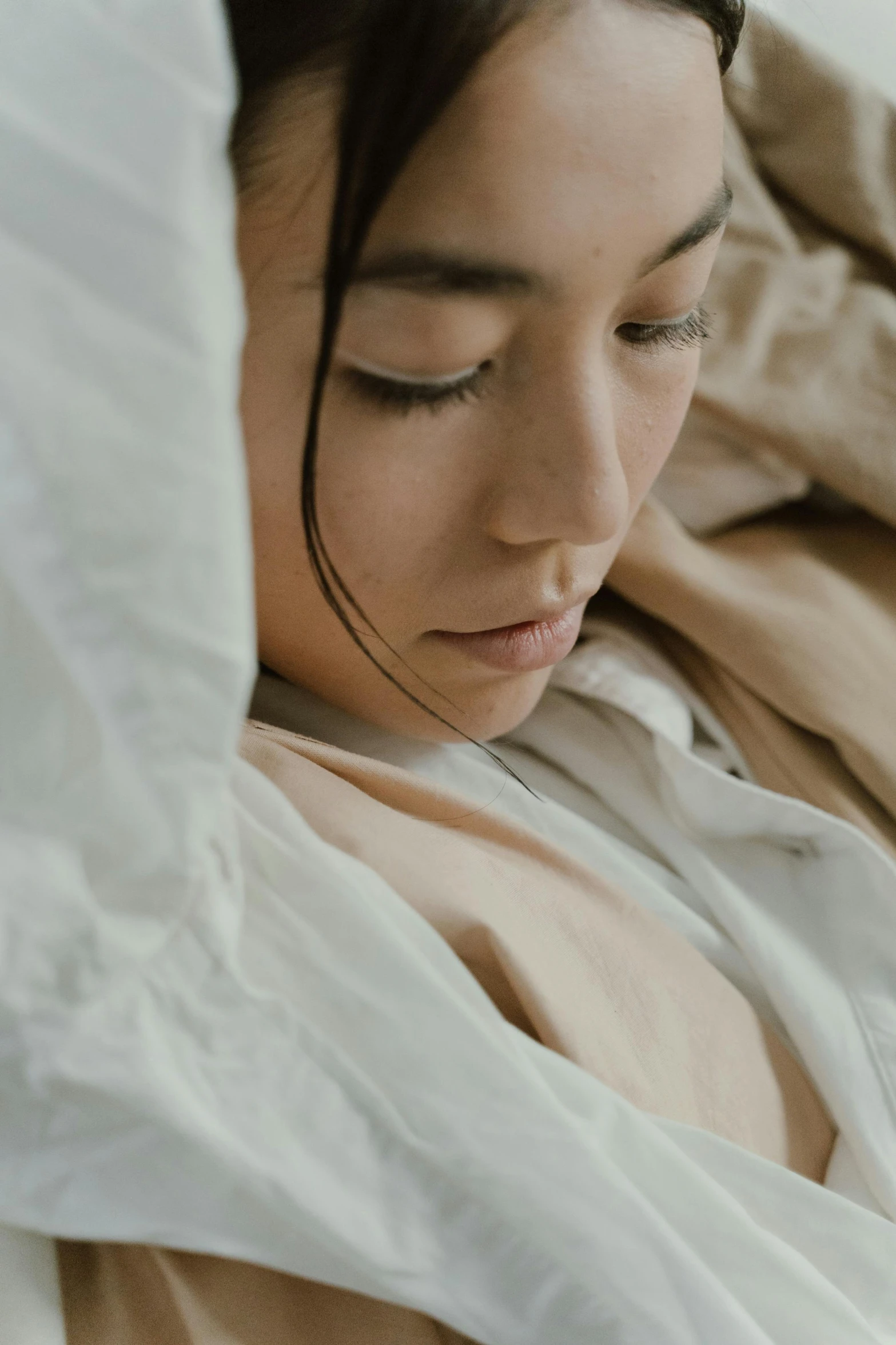 a woman laying in bed with her eyes closed, trending on pexels, visual art, close up character, covered with blanket, kiko mizuhara, linen