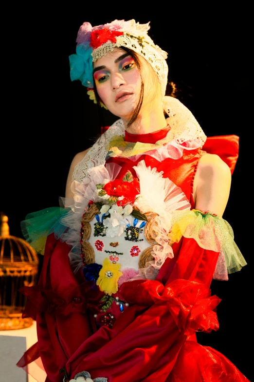 a woman in a red dress standing next to a bird cage, an album cover, inspired by Fujiwara Takanobu, rococo, artdoll, multicoloured, on the runway, (neotokyo)