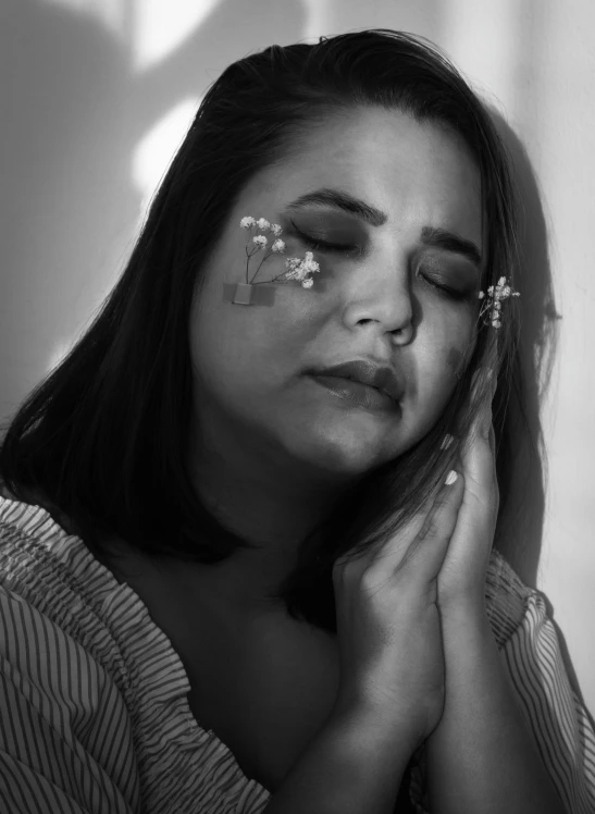 a black and white photo of a woman with her eyes closed, by Briana Mora, her face hurts, flowery, painful, photo taken in 2 0 2 0
