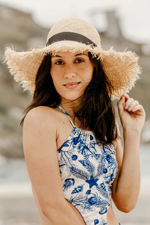 a woman standing on a beach wearing a hat, perfect natural skin tones, wearing a hawaiian dress, bedhead, halter top