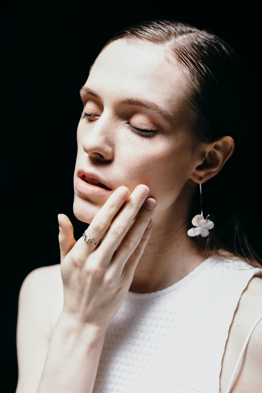 a woman with her hands on her face, a digital rendering, by Nina Hamnett, trending on unsplash, van cleef & arpels, delicate fog, ear, large opaque blossoms