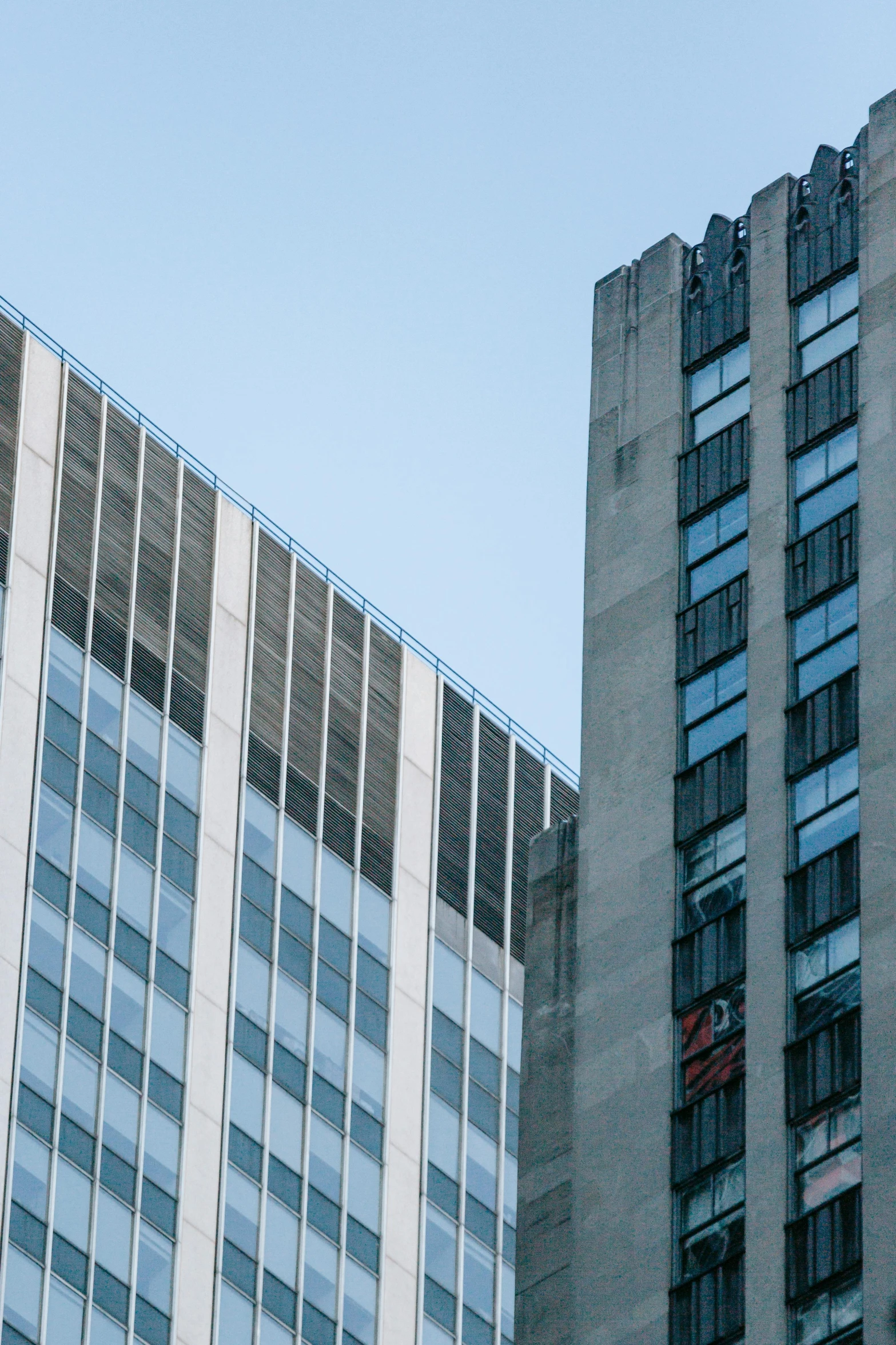 a couple of tall buildings next to each other, by Doug Ohlson, unsplash, brutalism, zoomed in, stalinist architecture, 2025, steel window mullions