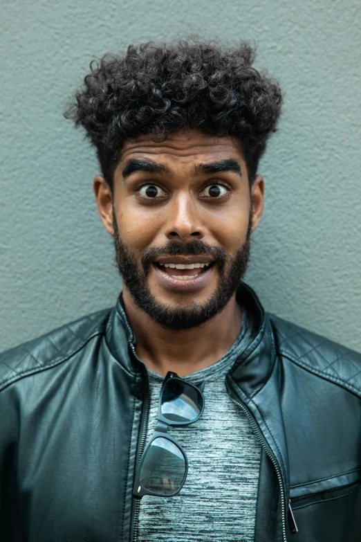 a close up of a person wearing a leather jacket, trending on pexels, renaissance, brown skin man with a giant grin, expressive surprised expression, aboriginal australian hipster, daniel oxford