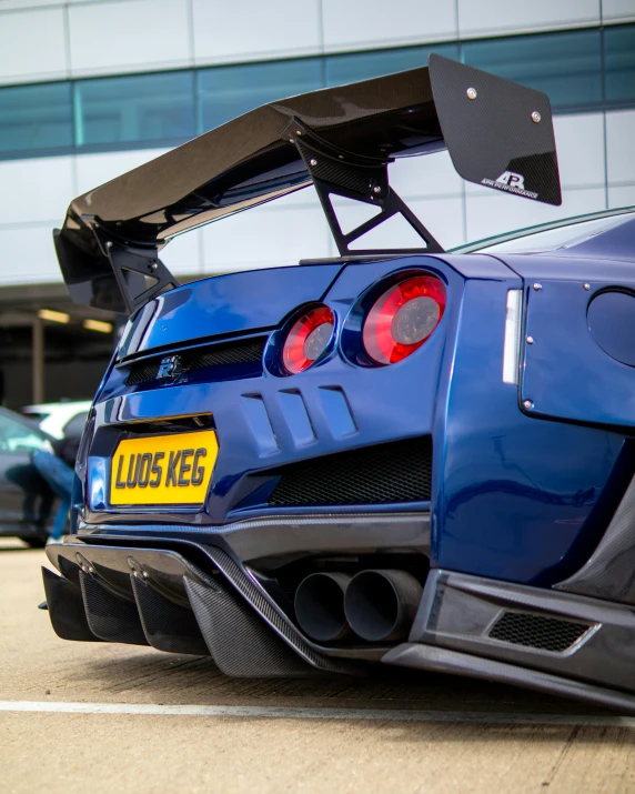 a blue sports car parked in front of a building