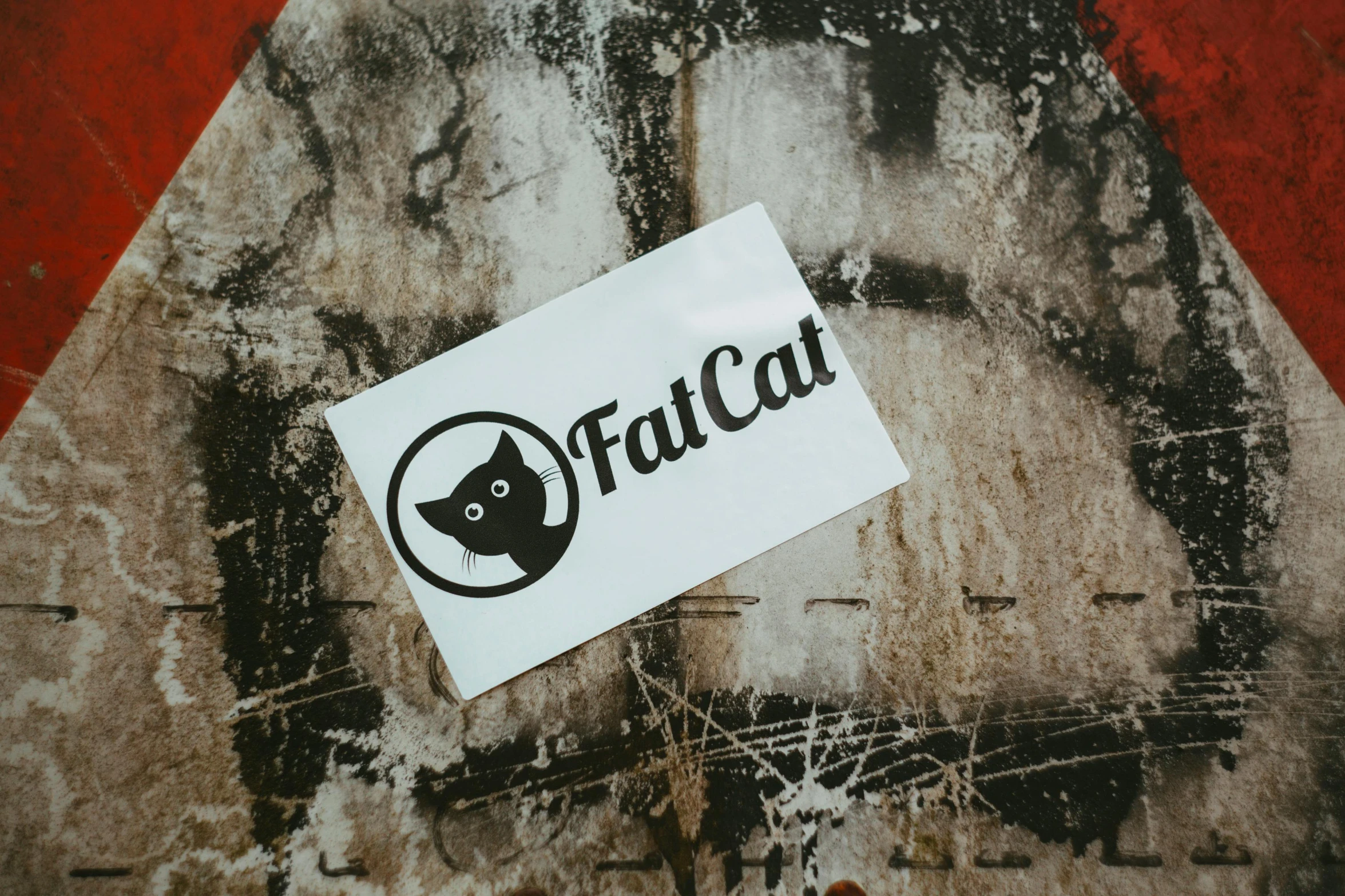 a sticker sitting on top of a stop sign, an album cover, graffiti, fat cat, official store photo, fulcolor octane reminder, rounded logo