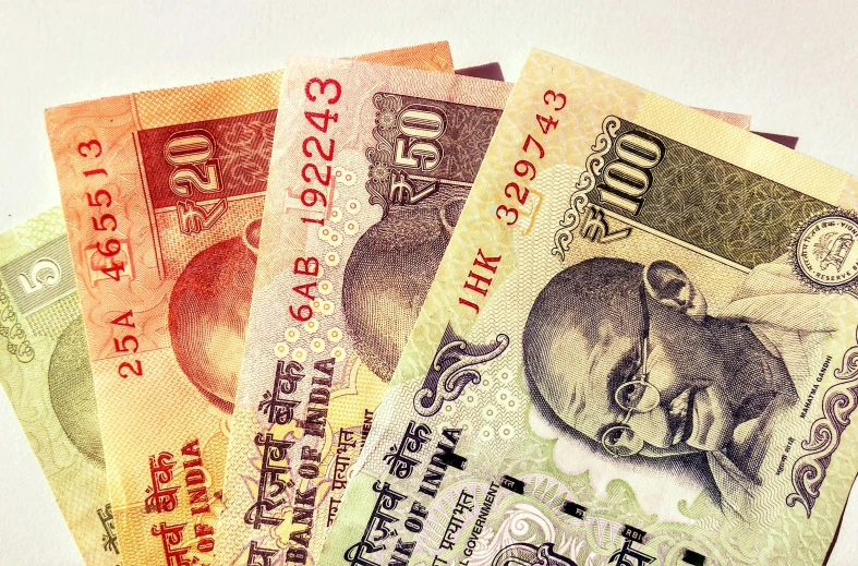 a pile of indian currency sitting on top of a table, by Matija Jama, pexels, art nouveau, three quater notes, thumbnail, 3 colour print, sifi