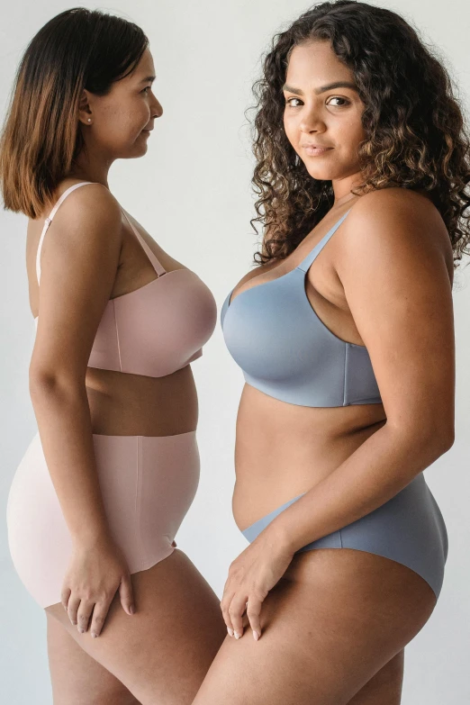 two women in underwear standing next to each other, soft curvy shape, all colors, d-cup, blue gray