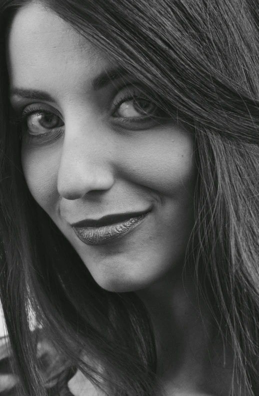 a black and white photo of a woman with long hair, pexels contest winner, half onesided smile, young middle eastern woman, high angle closeup portrait, monochrome:-2