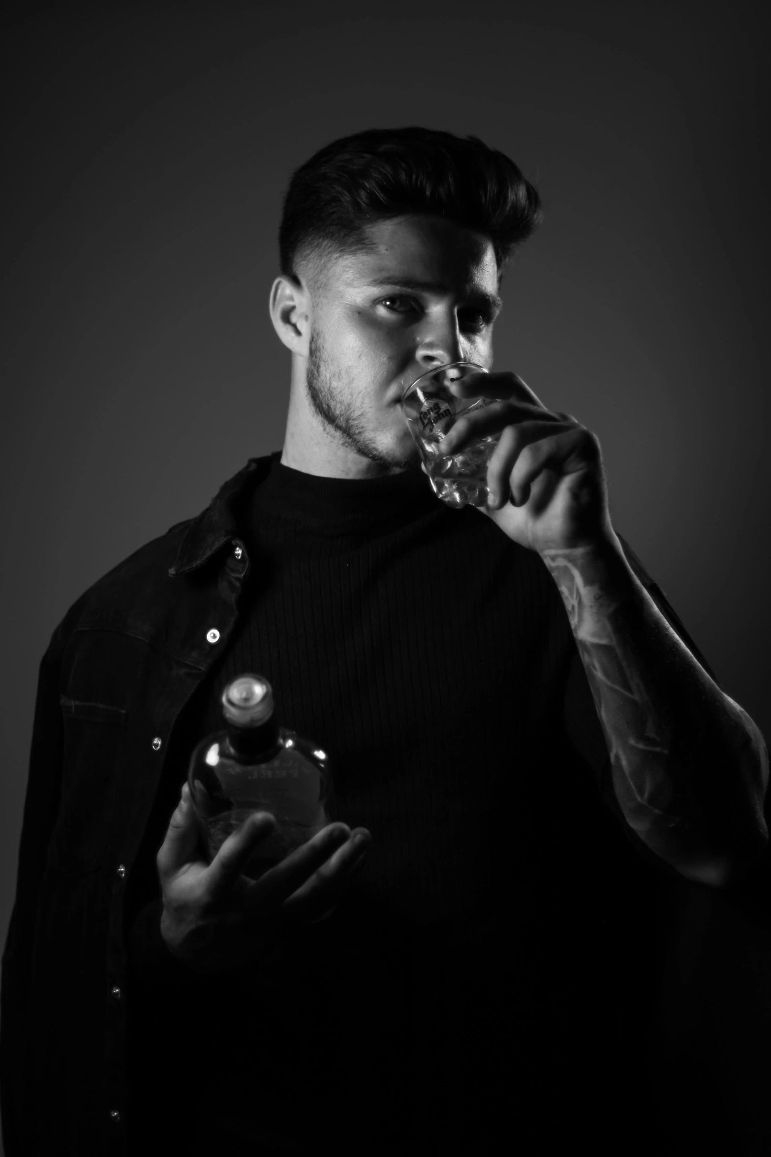 a black and white photo of a man drinking from a glass, by Cosmo Alexander, carrying a bottle of perfume, liam, ariel perez, pompadour