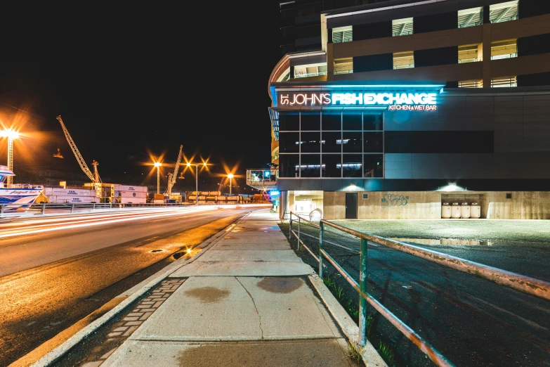 a city street at night with a building in the background, bright signage, profile image, nathan fowkes, black