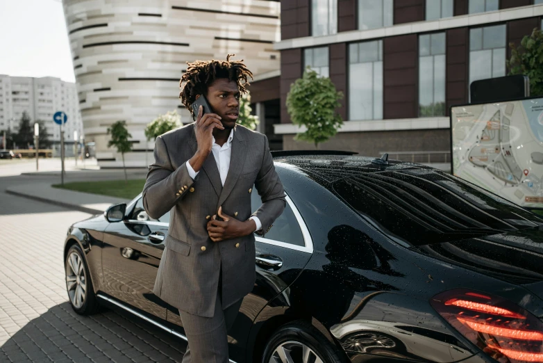 a man in a suit talking on a cell phone next to a car, pexels contest winner, renaissance, young thug, ( ( dark skin ) ), professional sports style, 1 4 9 3