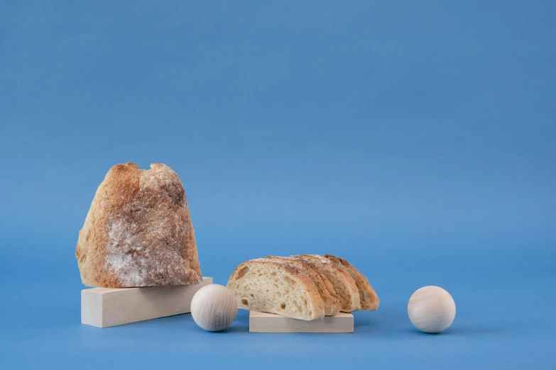 a loaf of bread sitting on top of a wooden block, a marble sculpture, inspired by Sarah Lucas, new sculpture, backscatter orbs, high quality product photo, fossil ornaments, award - winning crisp details