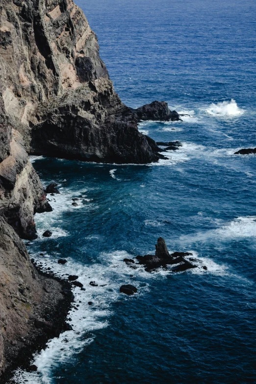 a man standing on top of a cliff next to the ocean, quixel megascans, slide show, brown, rough seas