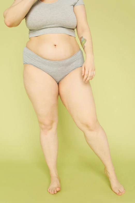 a woman in grey underwear posing for a picture, slightly fat, promo image, bloated, uncrop
