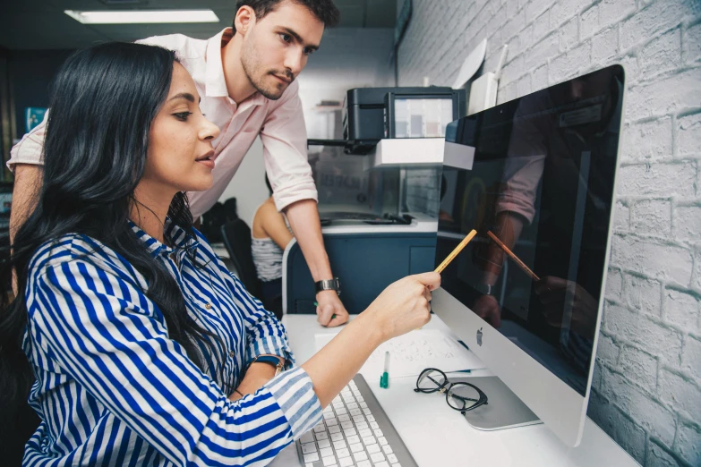 a man and woman looking at a computer screen, a digital rendering, pexels, quality draughtmanship, 9 9 designs, teaching, lachlan bailey