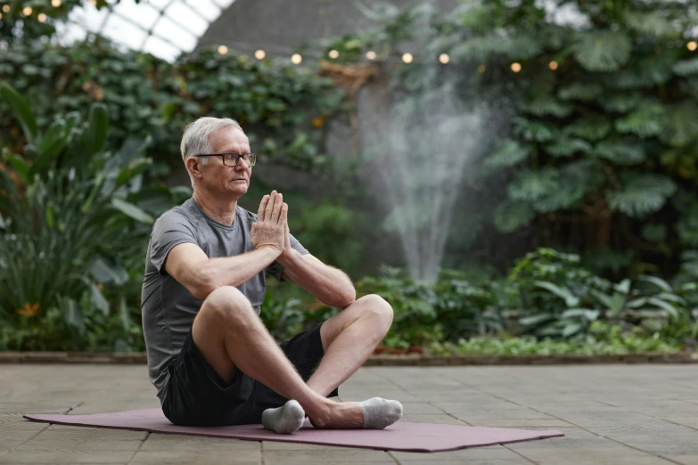 a man sitting on top of a pink yoga mat, pexels contest winner, botanic garden, older male, inviting posture, avatar image