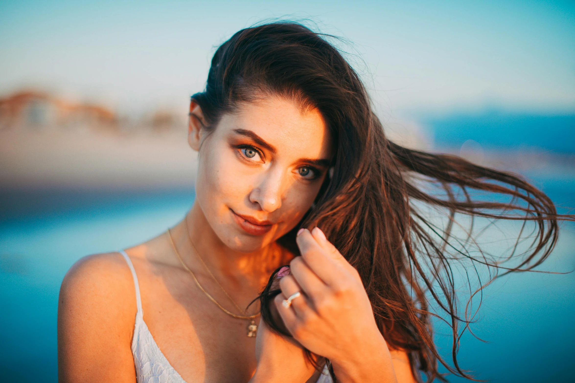 a beautiful young woman standing next to a body of water, by Julia Pishtar, pexels contest winner, tachisme, attractive facial features, :: madison beer, natalia dyer, at a beach