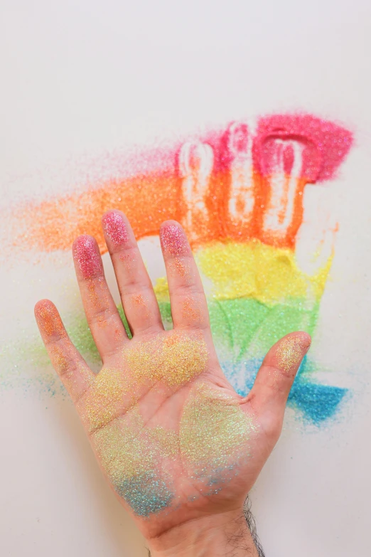 a person's hand with colored powder on it, a child's drawing, inspired by Okuda Gensō, trending on pexels, glitter gif, made of candy, stipple, lesbians