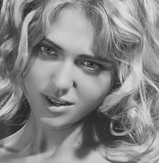 a black and white photo of a woman with long hair, a black and white photo, by Dimitre Manassiev Mehandjiysky, kate upton, with haunted eyes and curly hair, pastel, gif