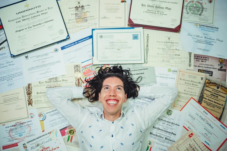 a woman laying on top of a pile of certificates, by Matthias Stom, pexels contest winner, while smiling for a photograph, diego fernandez, rebecca sugar, curls on top of his head