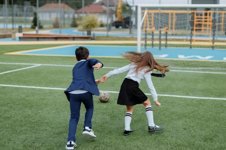 a couple of kids playing a game of soccer, an album cover, pexels contest winner, incoherents, school uniform, anna nikonova, vfx shot, instagram picture