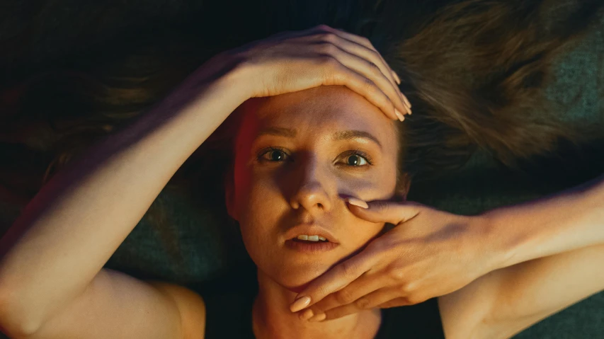 a woman laying down with her hands on her head, unsplash contest winner, photorealism, saoirse ronan, flume, golden glow, press shot