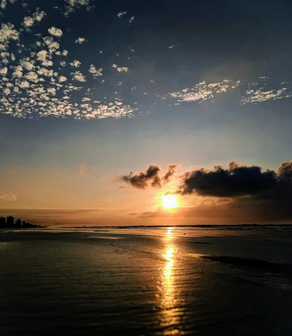 the sun is setting over the water on the beach, a picture, by Robbie Trevino, hurufiyya, today\'s featured photograph 4k, photo on iphone, wide angle photograph, humid evening