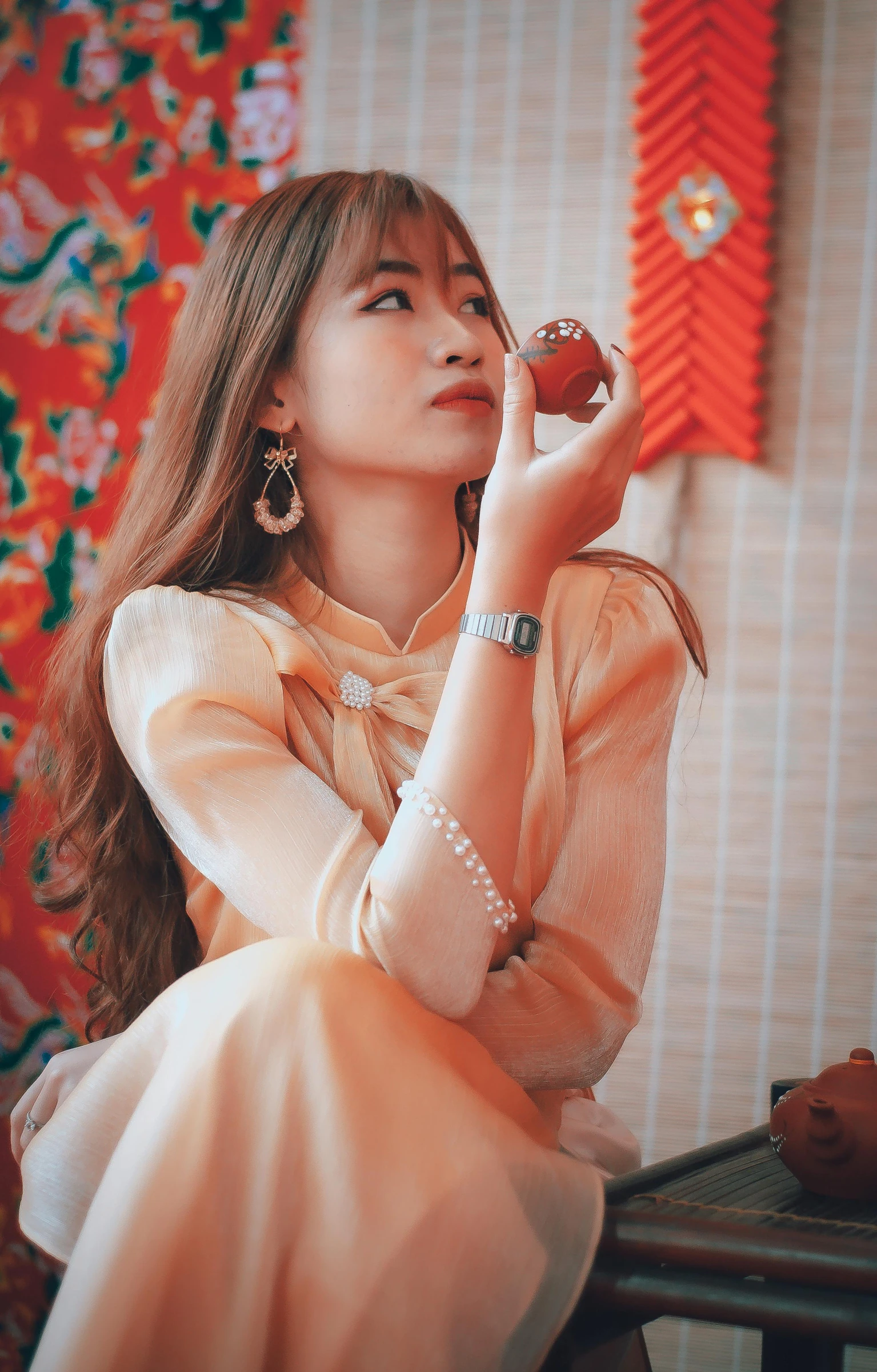 a woman sitting at a table eating a donut, a picture, inspired by Tang Di, trending on pexels, visual art, ao dai, red jewelry, wearing elegant casual clothes, vintage shading