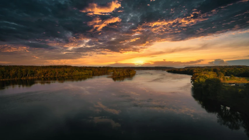 a large body of water under a cloudy sky, during a sunset, rivers, wide angle river, landscape photo-imagery