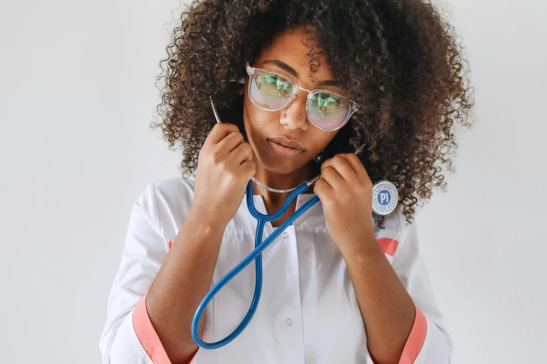 a close up of a person with a stethoscope, by Julia Pishtar, pexels, nerdy black girl super hero, with a lab coat, with afro, schools