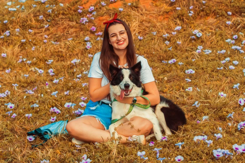 a woman sitting in a field with a dog and a baby, a portrait, by Julia Pishtar, pexels contest winner, border collie, avatar image, girl in flowers, handsome girl