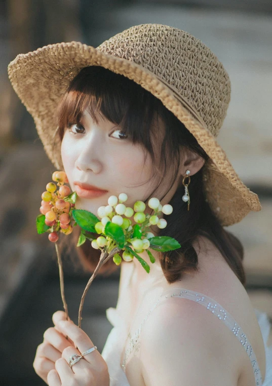 a woman in a straw hat holding a flower, a picture, by Tan Ting-pho, unsplash, realism, brown hair with bangs, girl with a pearl earringl, ulzzang, vibrant.-h 704