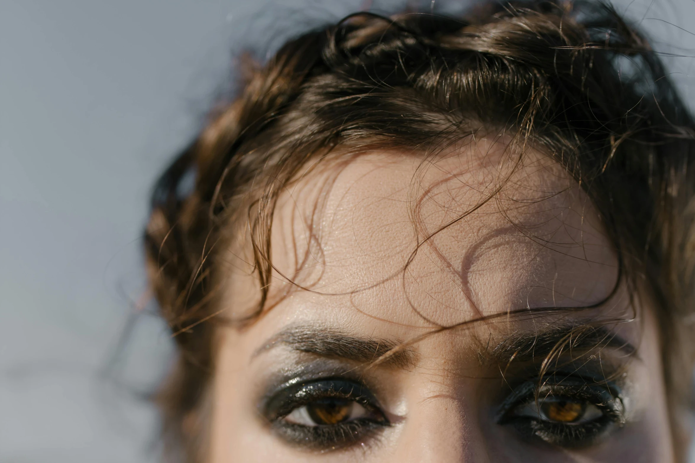 a close up of a woman with brown eyes, an album cover, trending on pexels, hair like dark clouds, shot on sony a 7, black sclera, high angle close up shot