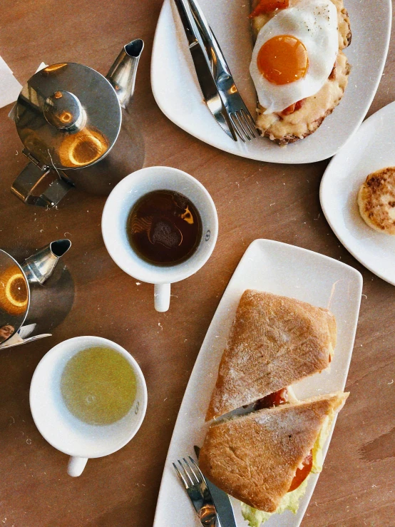 a table topped with plates of food and cups of coffee, thumbnail, bread, panini, abcdefghijklmnopqrstuvwxyz